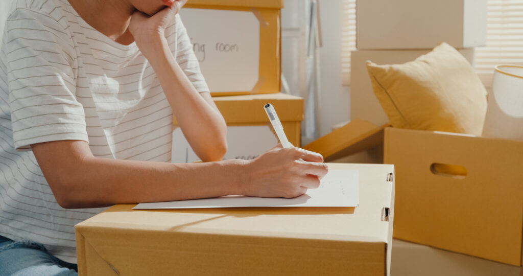 Close up shot of someone filling out a checklist for packing