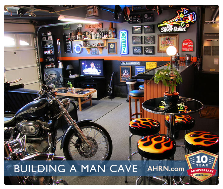 A military man cave with a motorcycle and flame bar stools.