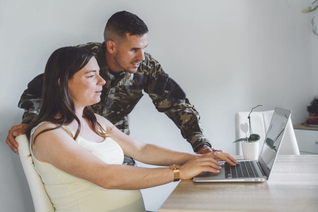Military spouse searching for a job while being supported by partner.